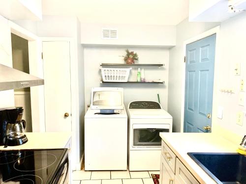 a white kitchen with a stove and a microwave at Welcome travel workers, King bed, 2br 1 ,5 ba, 4beds sleep 5, Valero, Blue oval in Memphis