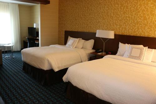 a hotel room with two beds and a lamp at Fairfield Inn & Suites by Marriott Bowling Green in Bowling Green