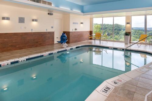 a swimming pool with blue water in a building at Fairfield Inn & Suites by Marriott Huntington in Huntington