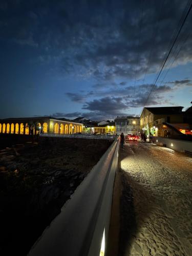 a person walking down a street at night at Chalé Orion in Lençóis