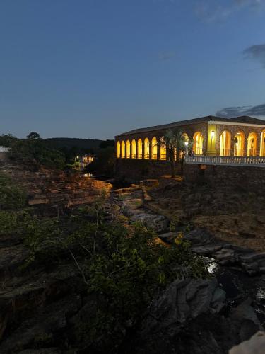a building lit up at night on the rocks at Chalé Orion in Lençóis