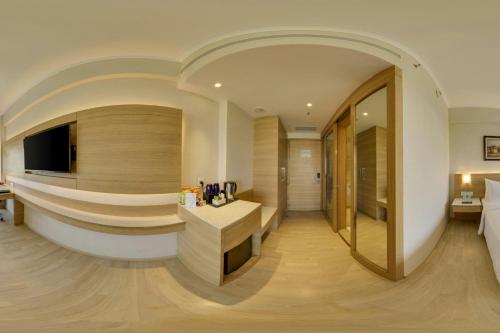 a hotel room with a reception desk and a bed at Fairfield by Marriott Lucknow in Lucknow