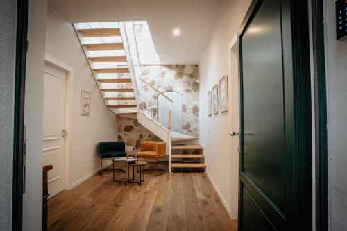 a hallway with a staircase and a room with a table and chairs at Dimora Lombardi in Matera