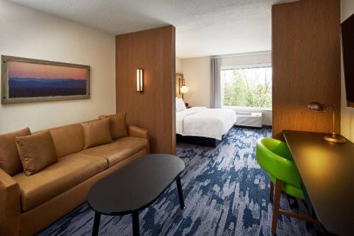 a hotel room with a couch and a bed at Fairfield Inn & Suites by Marriott Virginia Beach/Norfolk Airport in Virginia Beach