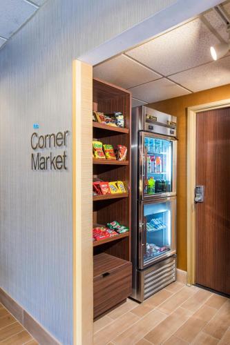an entrance to a store with a corner market refrigerator at Rodeway Inn in Pensacola