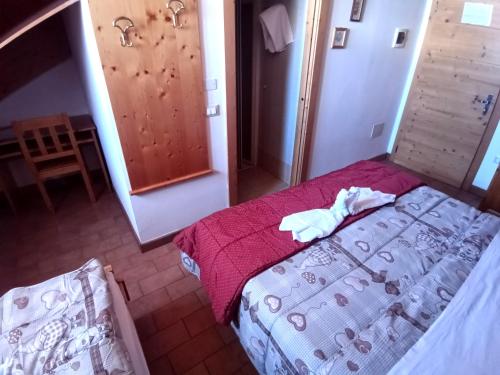 Postel nebo postele na pokoji v ubytování Rifugio Predaia Ai Todes'ci