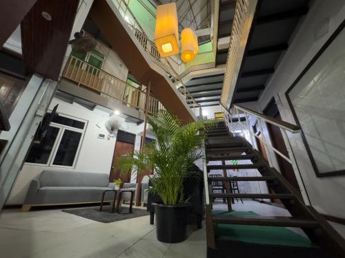 a spiral staircase in a room with a couch and chairs at The Park House in Male City