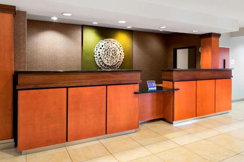a lobby with a counter and a vase on the wall at Fairfield Inn & Suites by Marriott Hobbs in Hobbs