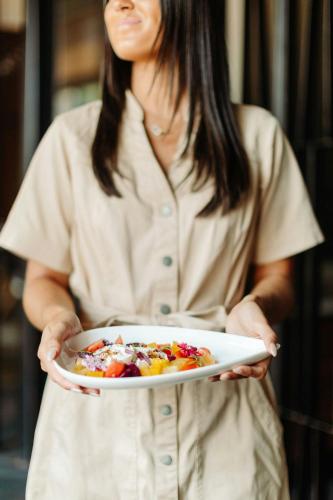 a woman is holding a plate of food at Baltimore Marriott Waterfront in Baltimore