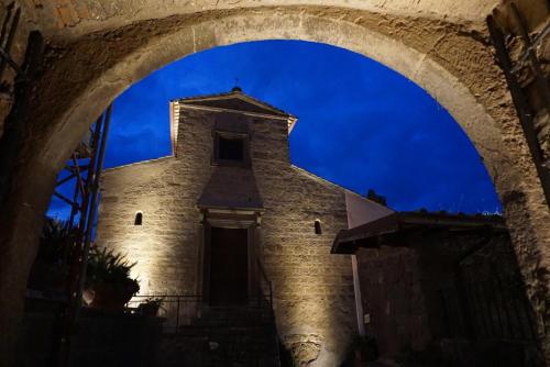 an archway in front of a building with a blue sky at La Locanda del Pellegrino in Bassano in Teverina