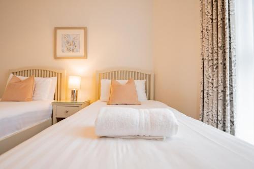 a bedroom with two beds and a window at Long Walk Gem in Galway