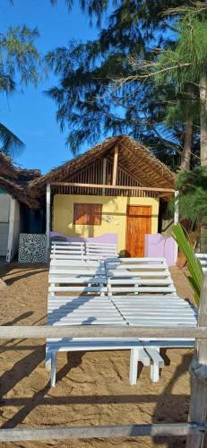 a white bench sitting in front of a house at Surf &Turf Arugam Bay in Arugam Bay