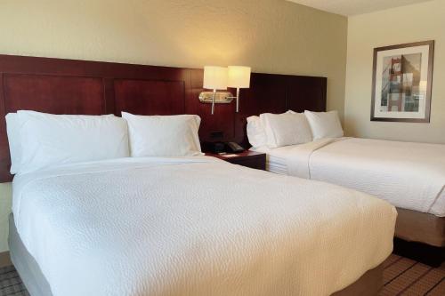 a hotel room with two beds with white sheets at Four Points by Sheraton San Rafael Marin County in San Rafael