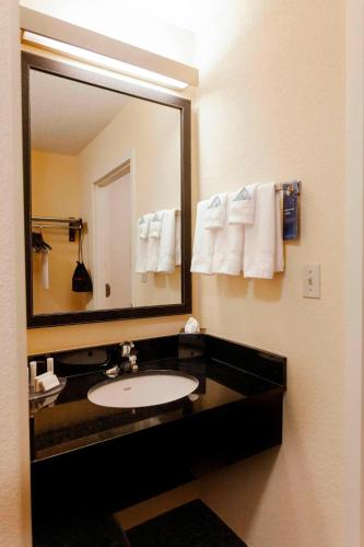 a bathroom with a sink and a large mirror at Fairfield Inn by Marriott Ponca City in Ponca City