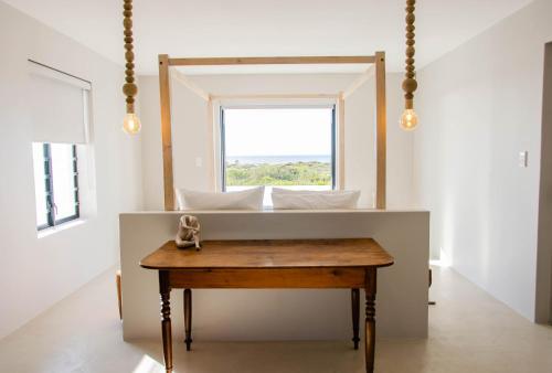 a room with a table with a mirror and a window at Bella La Vita Beachfront Villa in Velddrif