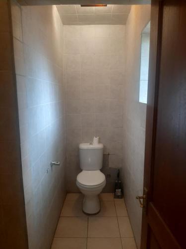 a small bathroom with a toilet in a room at Yolkel guesthouse in Germiston