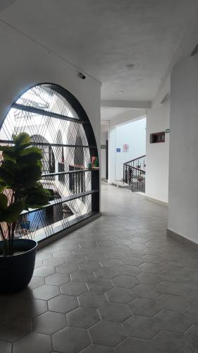 a hallway with a potted plant in a building at HOTEL CHURUMUCO in San José Iturbide