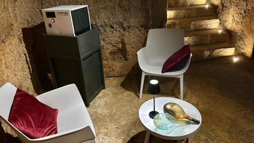 a room with chairs and a table with a bowl on it at Palazzo Palloni: Piano Nobile in Sorano