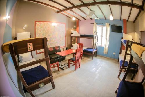 a room with bunk beds and a table and chairs at Funk Bunks - Mount View in Kandy