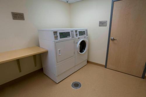 a laundry room with a washing machine and a door at Fairfield Inn & Suites by Marriott Geneva Finger Lakes in Geneva