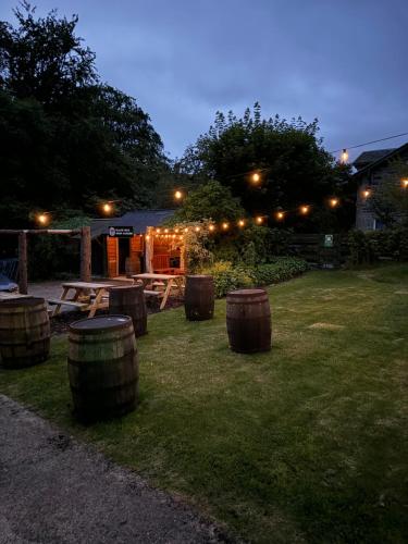 a picnic table and barrels in a yard at night at The Retreat Hotel in Strathpeffer