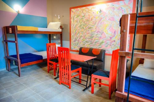 a room with a table and chairs and bunk beds at Funk Bunks - Mount View in Kandy