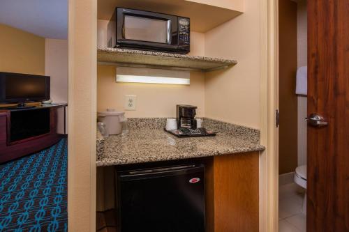 a hotel room with a kitchen with a microwave at Fairfield Inn Dulles Airport Chantilly in Chantilly