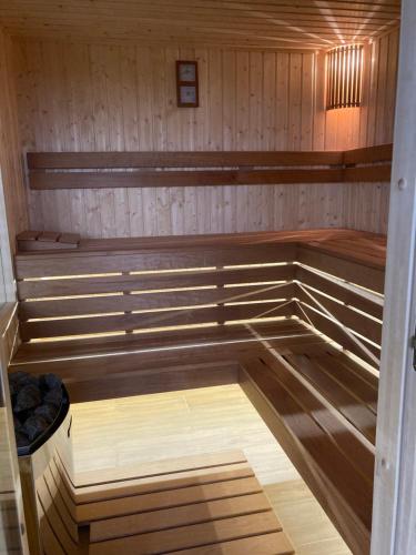 a sauna with wood paneled walls and a wooden floor at Lila akác vendégház in Keszü