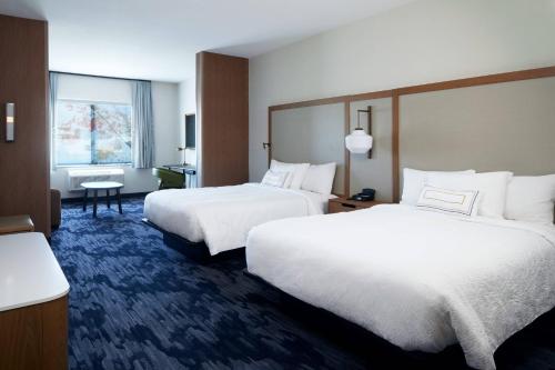 a hotel room with two beds and a window at Fairfield Inn & Suites by Marriott Riverside Moreno Valley in Moreno Valley