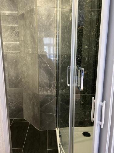 a shower with a glass door in a bathroom at Eifelerhof hotel Monschau in Monschau