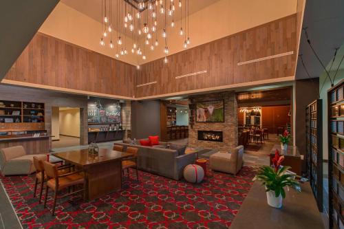 a large living room with a couch and a fireplace at Four Points by Sheraton Midland in Midland
