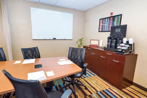 a conference room with a table and chairs at Fairfield by Marriott Medford Long Island in Medford