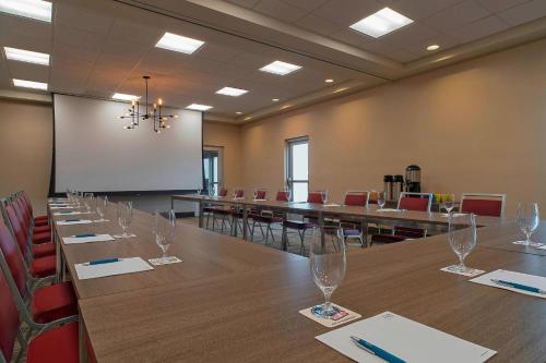 a conference room with a long table and chairs at Four Points by Sheraton Midland in Midland
