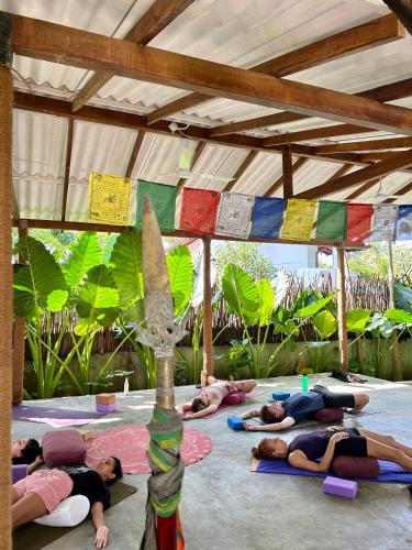 a group of people doing yoga in a tent at One Bhakthi in Ahangama
