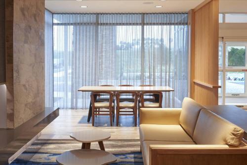 a living room with a couch and a table at Fairfield Inn & Suites Vero Beach in Vero Beach