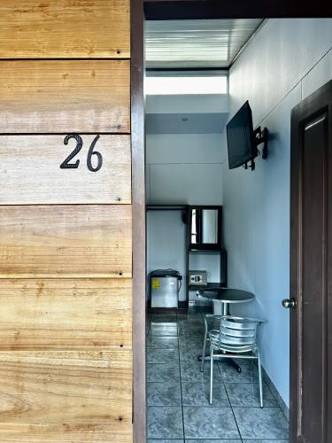 a room with a table and a sign on the wall at Hotel Arenal Rabfer in Fortuna
