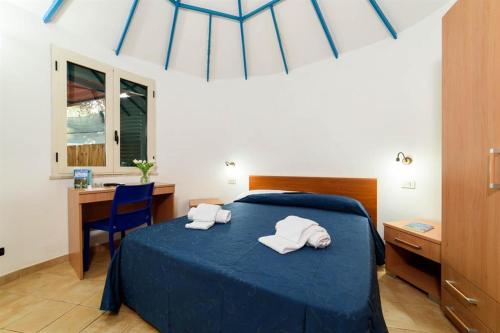 a bedroom with a bed with two towels on it at Villaggio Camping Odissea in Marina di Camerota