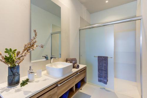 a bathroom with a sink and a mirror at Punto Novo in Nuevo Vallarta 