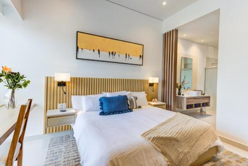 a bedroom with a large bed and a desk at Punto Novo in Nuevo Vallarta 