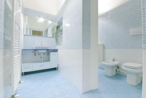 a white bathroom with a toilet and a sink at SUPER CENTRAL - Antique flat in Bologna