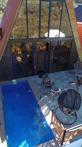a view of a swimming pool on a house at 40 steps Aframe House in Uçgün