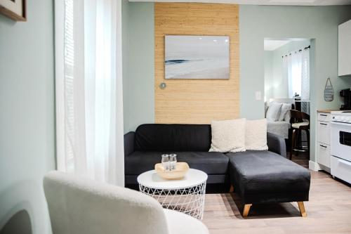 a living room with a black couch and a table at Petite Paradise in Dayton