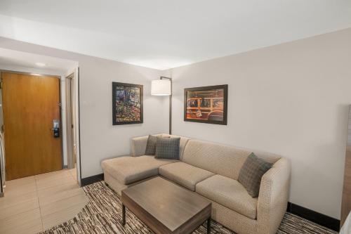a living room with a couch and a table at Holiday Inn Express & Suites Hayward by IHG in Hayward