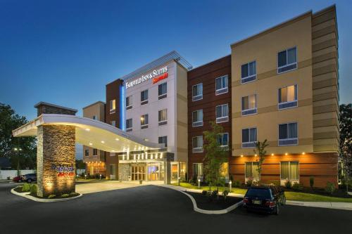 a hotel with a car parked in a parking lot at Fairfield Inn & Suites by Marriott New Castle in New Castle