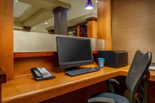a desk with a computer and a phone on it at Fairfield by Marriott Peoria East in Peoria