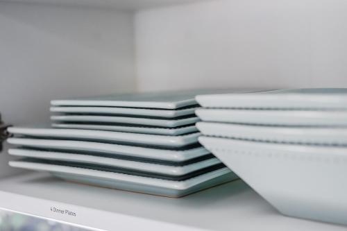 a stack of white plates sitting on a shelf at Tiny Home for a King in Dayton