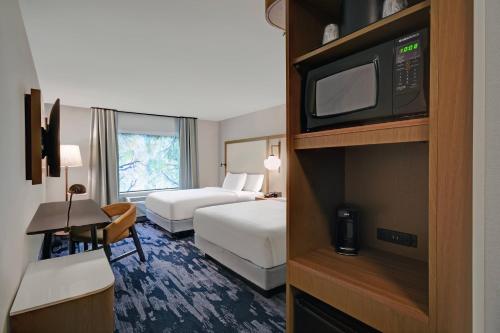 a hotel room with two beds and a television at Fairfield by Marriott Inn & Suites Mansfield in Mansfield