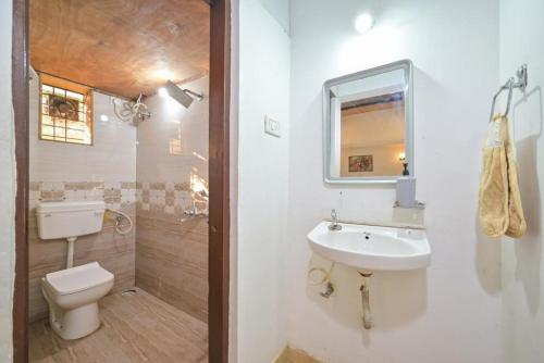a bathroom with a toilet and a sink at Kashmira Villa in Malavli