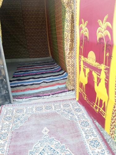 an entrance to a room with a rug on the floor at Camp trip Merzouga in Merzouga
