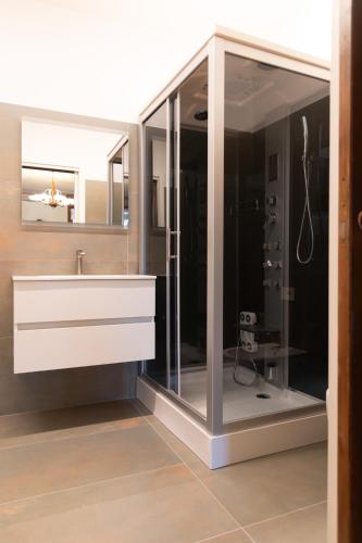 a bathroom with a sink and a mirror at B&B al Torrione Belluno in Belluno